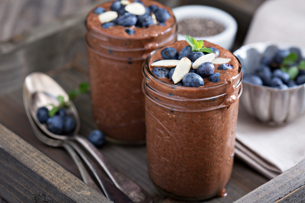 Cans filled with Avocado Chocolate Mousse topped with blueberries