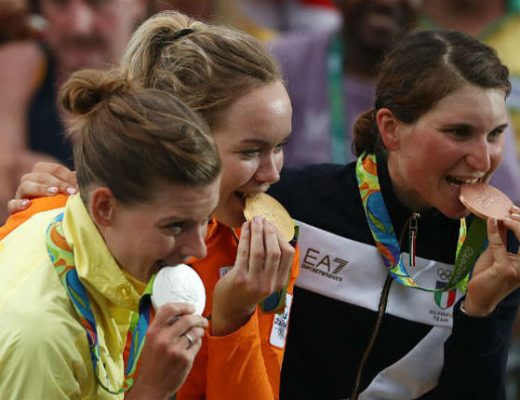 Olympian at Rio 2016 biting their medals