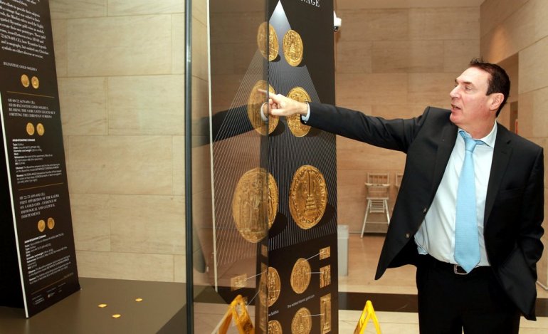 Dr. Alain Baron pointing at the coins at the Museum Of Islamic Art - Qassim Rahmatullah/The Peninsula